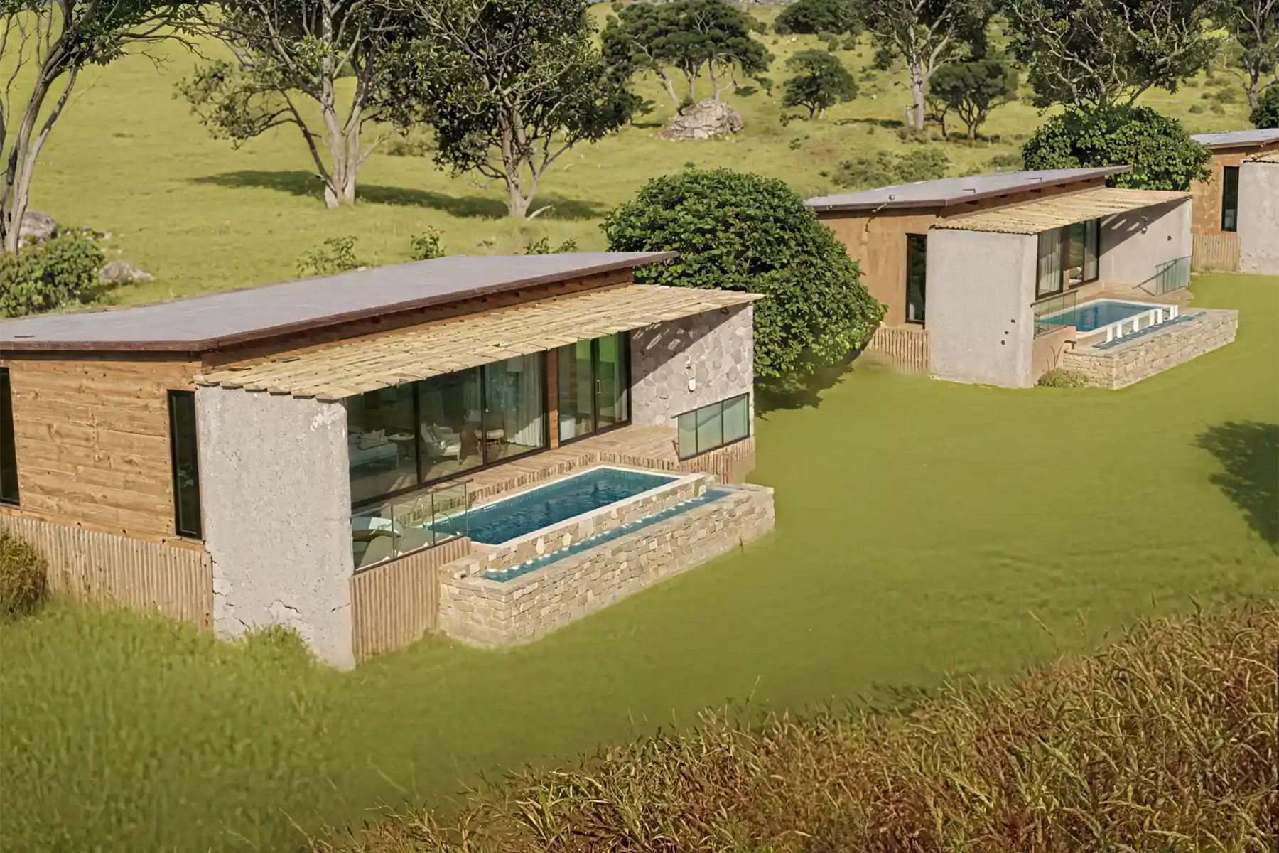 Architectural render of two luxury safari villas at The Bomas by Amani Collection Lobo Serengeti, each featuring a private plunge pool, stone and timber faÃ§ade, and floor-to-ceiling glass set into lush hillside grounds